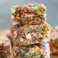 Fruity Pebble Rice Crispy Treats stacked on top of each other.