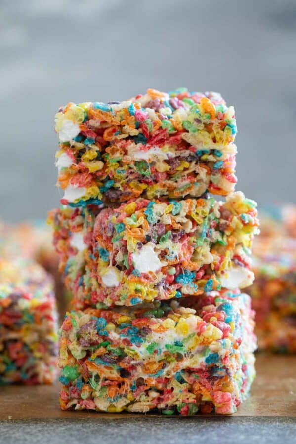 Fruity Pebble Rice Crispy Treats stacked on top of each other.