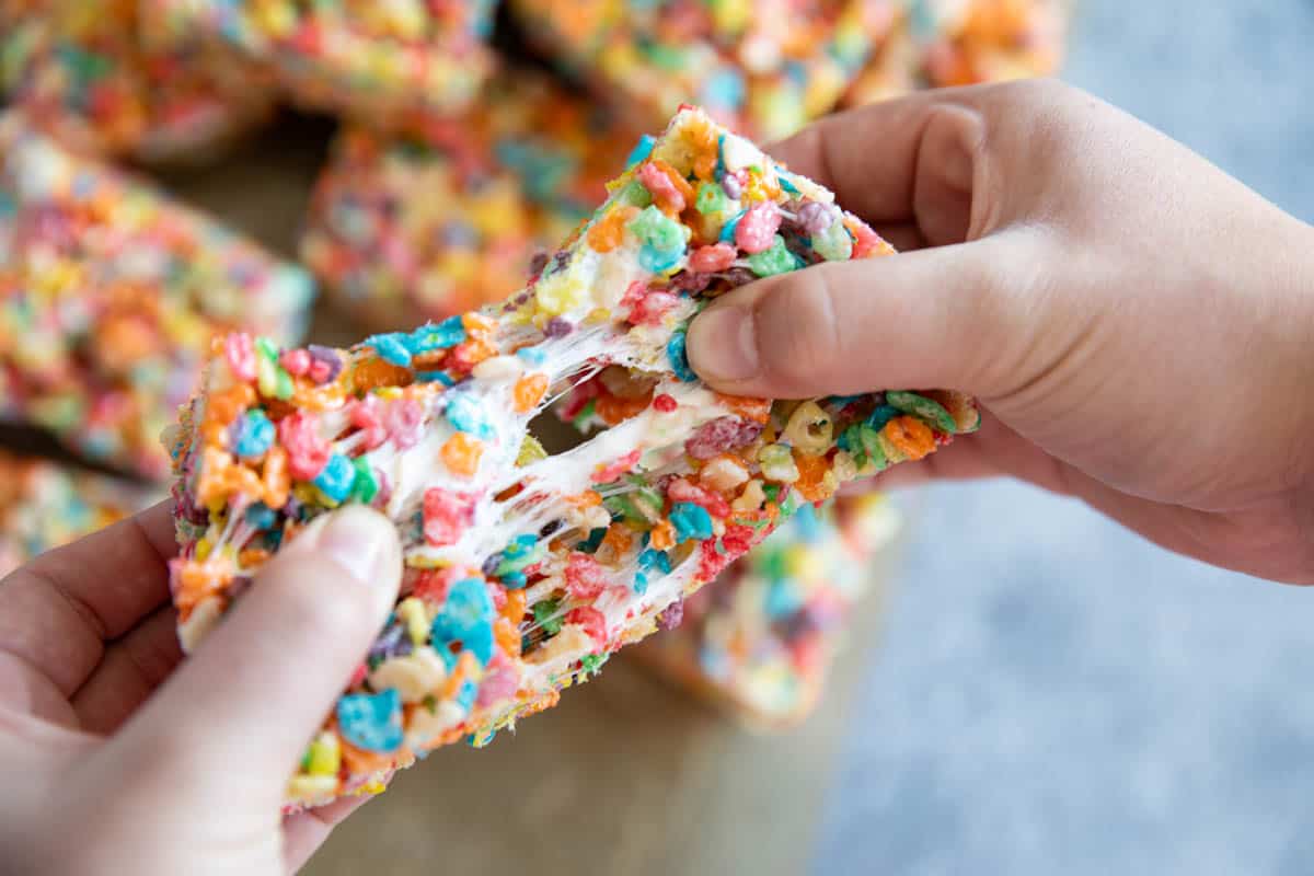 Pulling a rice crispy treat apart to show stretching marshmallows.