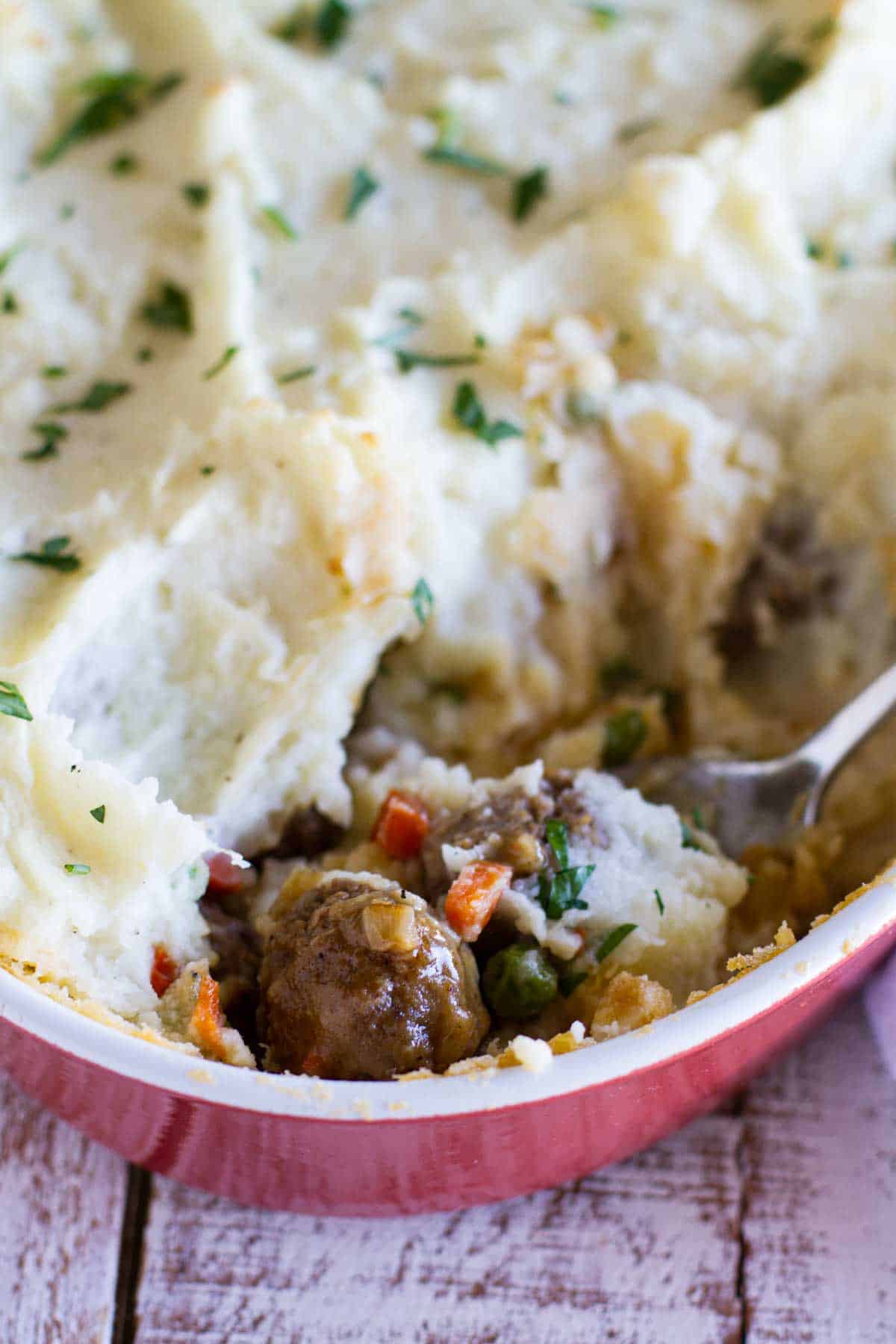 Meatball cottage pie, showing interior with meatballs and vegetables.