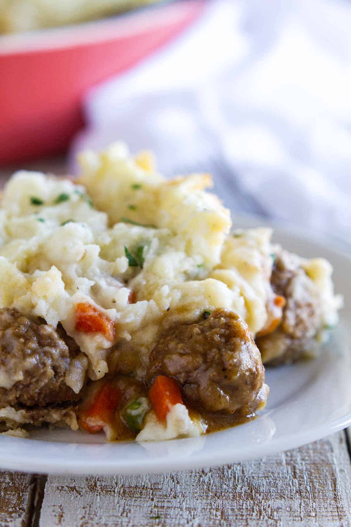 Serving of meatball cottage pie on a plate.