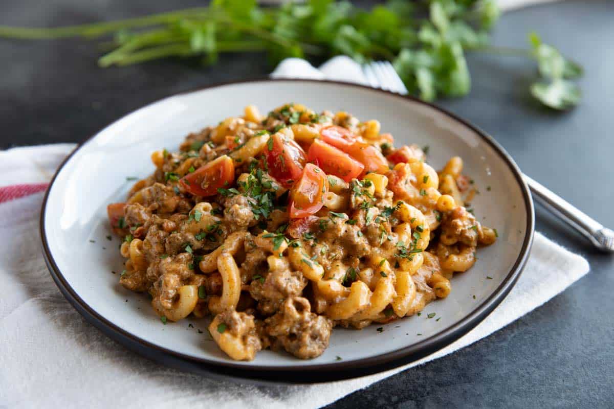 Plate with Taco Mac and Cheese made with ground beef and cheddar cheese.