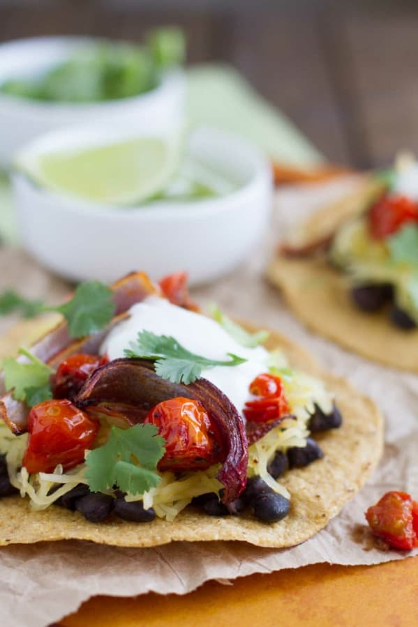 Vegetarian Tostadas made with black beans, spaghetti squash, onions, and tomatoes.