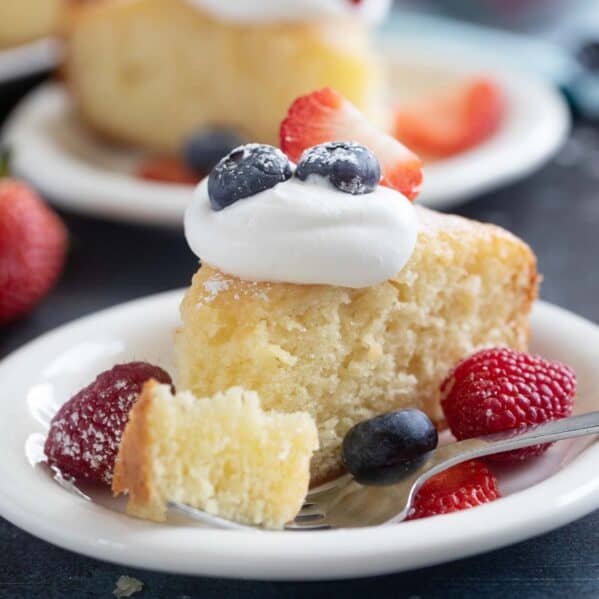 Slice of yogurt cake with a bite of cake on a fork.