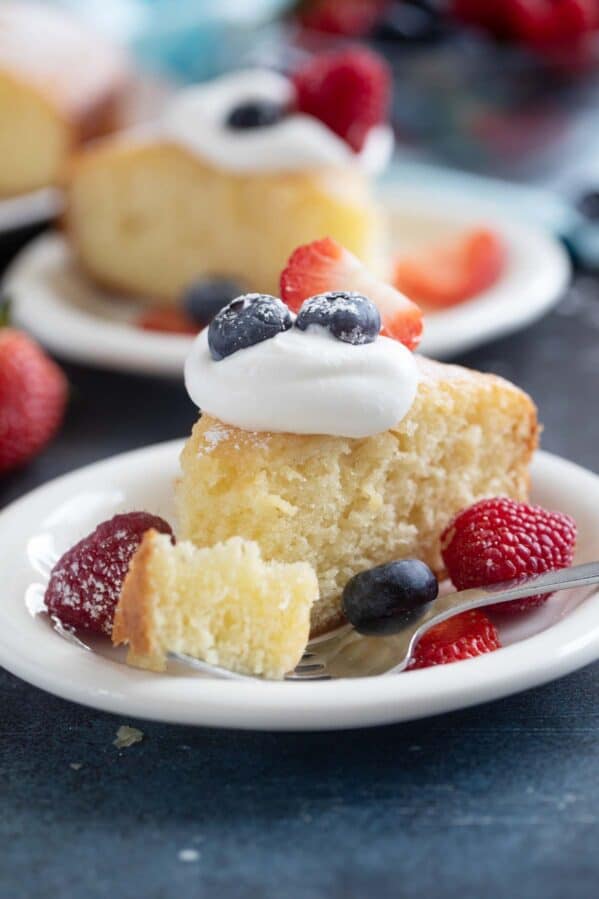 Slice of yogurt cake with a bite of cake on a fork.