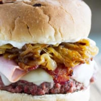 Triple Pork Burger - made with ground pork and topped with ham, bacon, and caramelized onions.