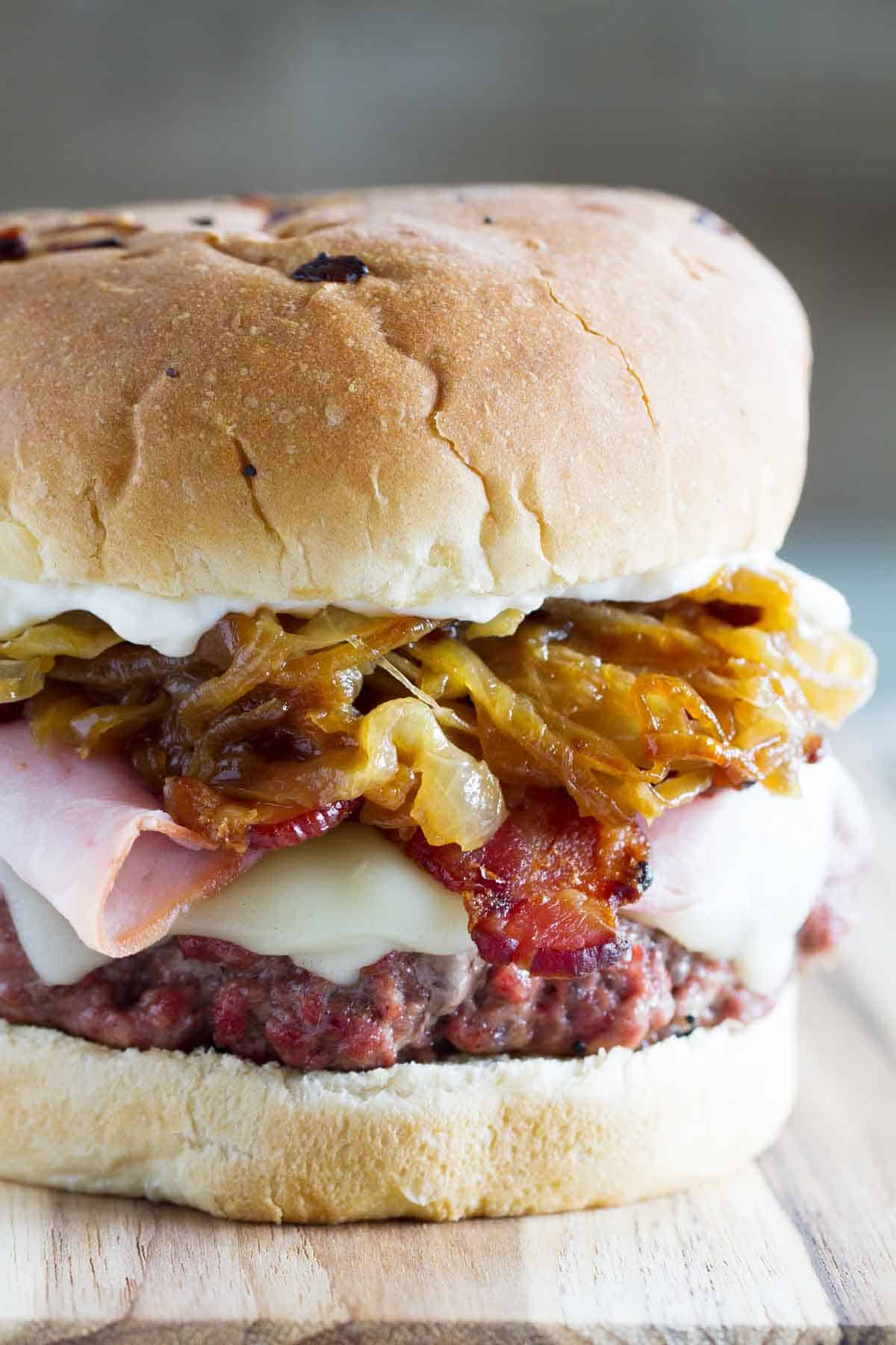 Triple Pork Burger - made with ground pork and topped with ham, bacon, and caramelized onions.