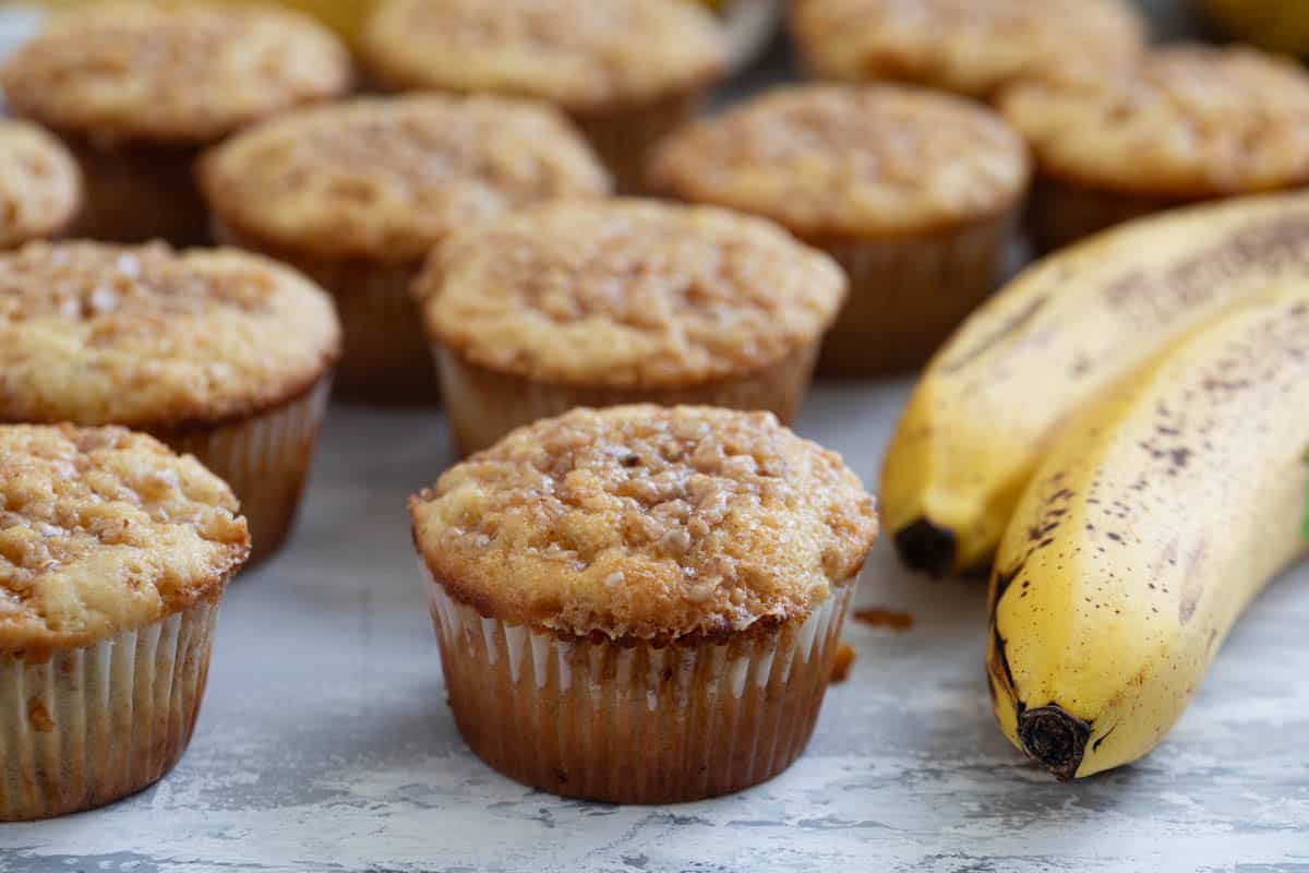 Banana Toffee Muffins topped with toffee bits.