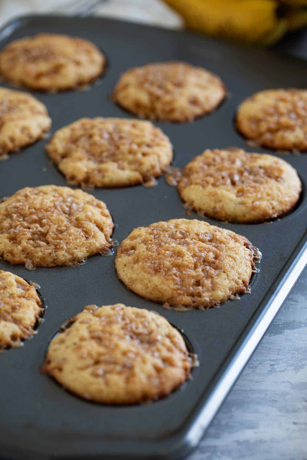 Banana toffee muffins in a muffin tin.