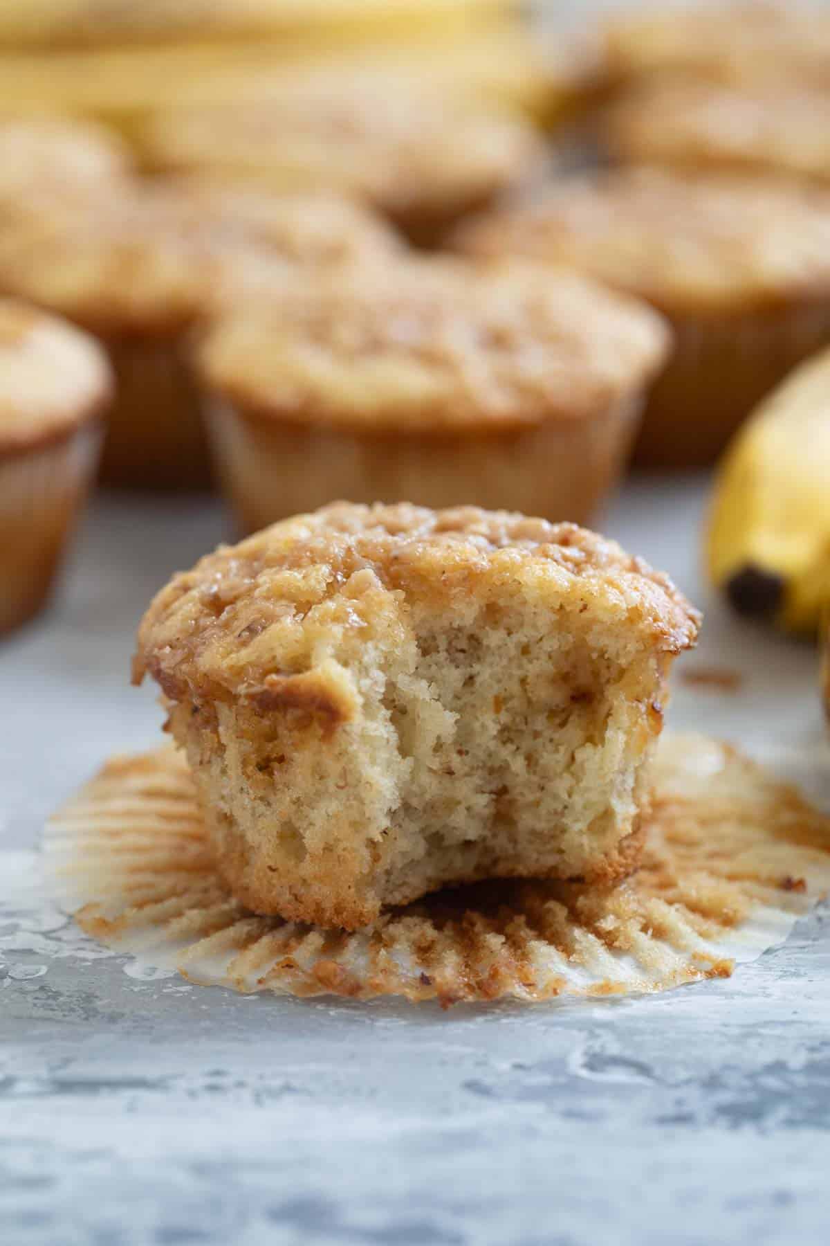 Banana toffee muffin with a bite taken out of it.