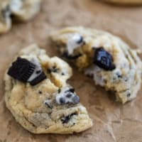 Cookies and Cream Cookie broken in half on parchment.