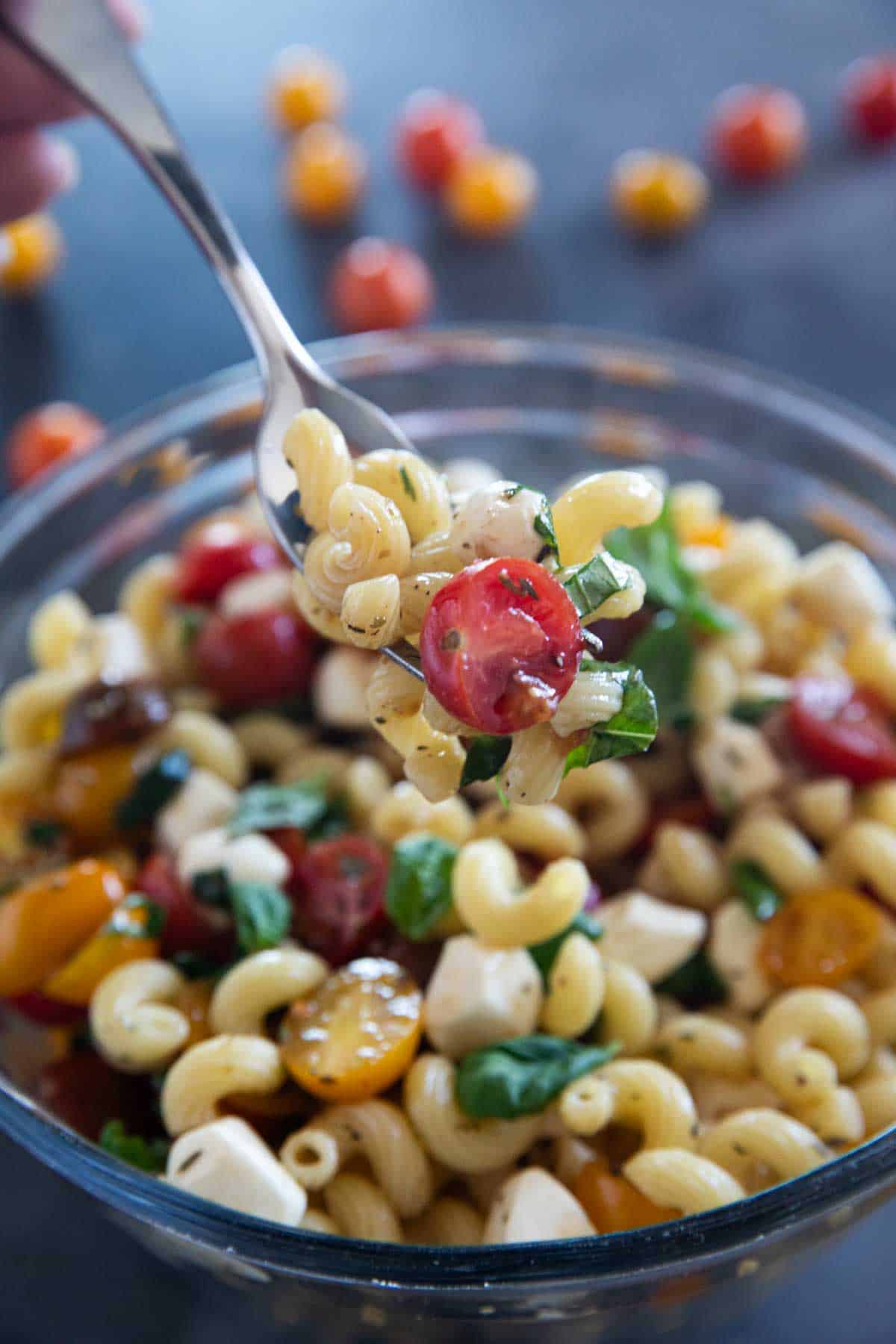 Fork with a bite full of Caprese Pasta Salad.