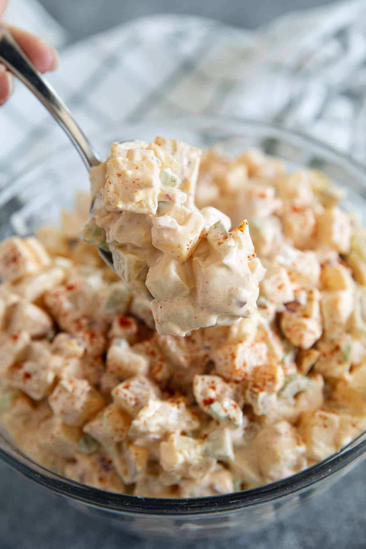Serving a spoon full of potato salad.