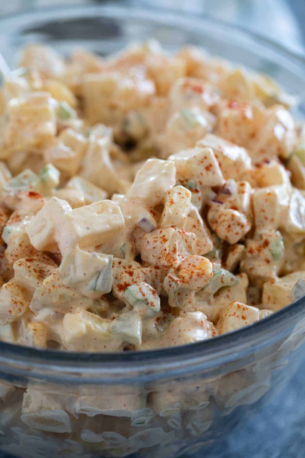 Bowl of potato salad sprinkled with smoked paprika.