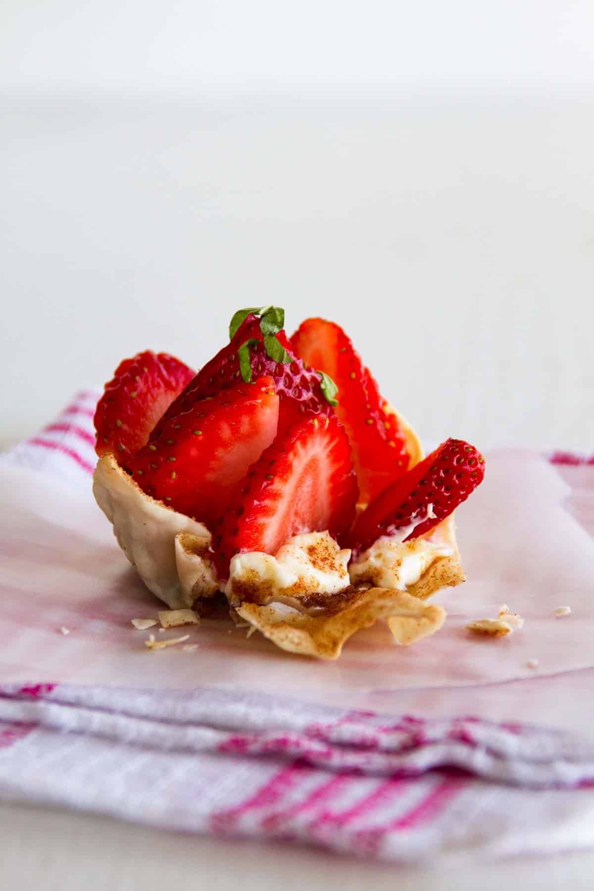 Strawberry Wonton Cup with the side broken to show filling.