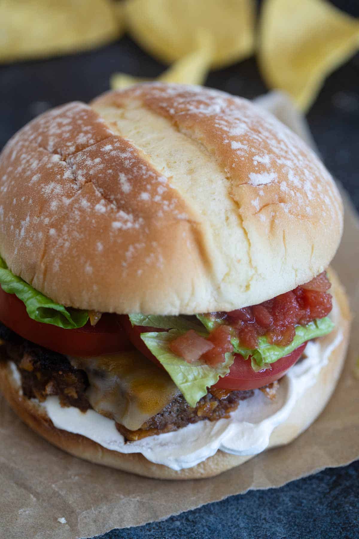 Taco burger on a piece of parchment paper.