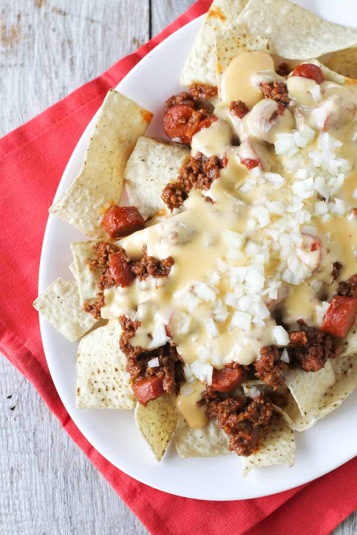 Plate filled with chili dog nachos.