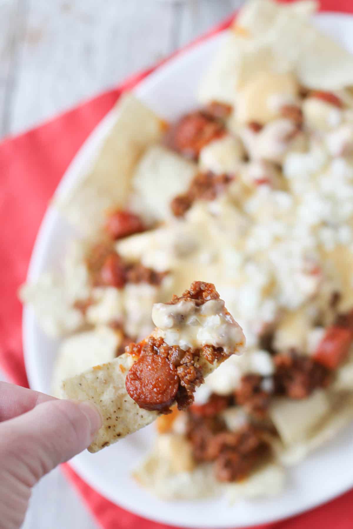 Taking a scoop of chili dog nachos.