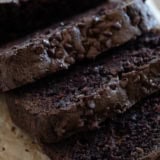 Slices of chocolate zucchini bread topped with mini chocolate chips.