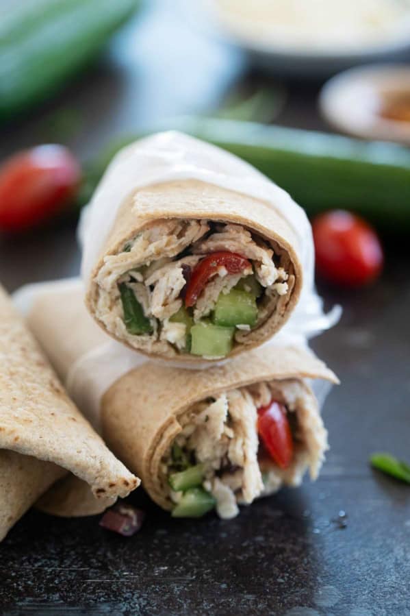 Greek Chicken Wraps with tomatoes, cucumbers, and olives.