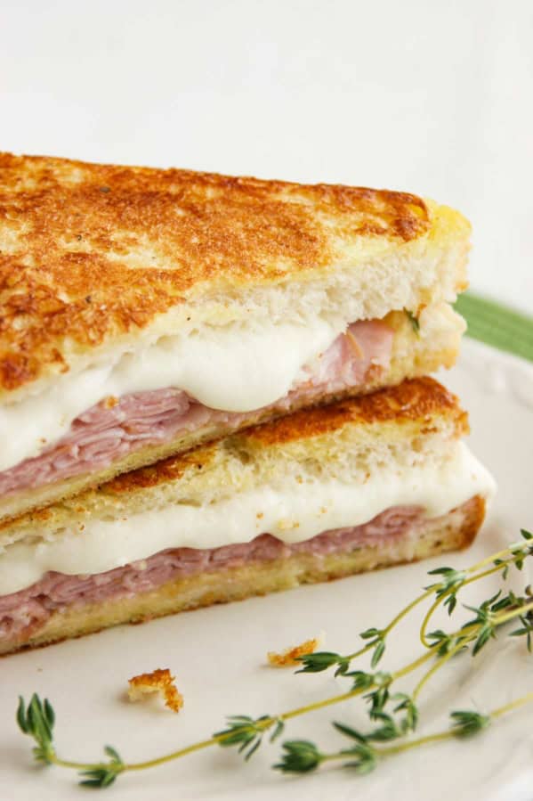 Italian Style Monte Cristo with honey mustard thyme sauce cut in half.