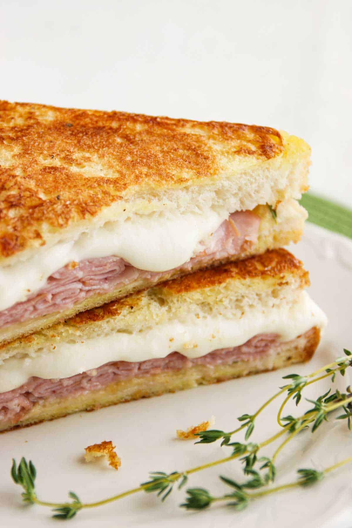 Italian Style Monte Cristo with honey mustard thyme sauce cut in half.