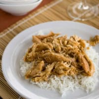 Plate with slow cooker chicken teriyaki over white rice.