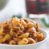 Sun Dried Tomato Pesto Pasta Salad in a white bowl.