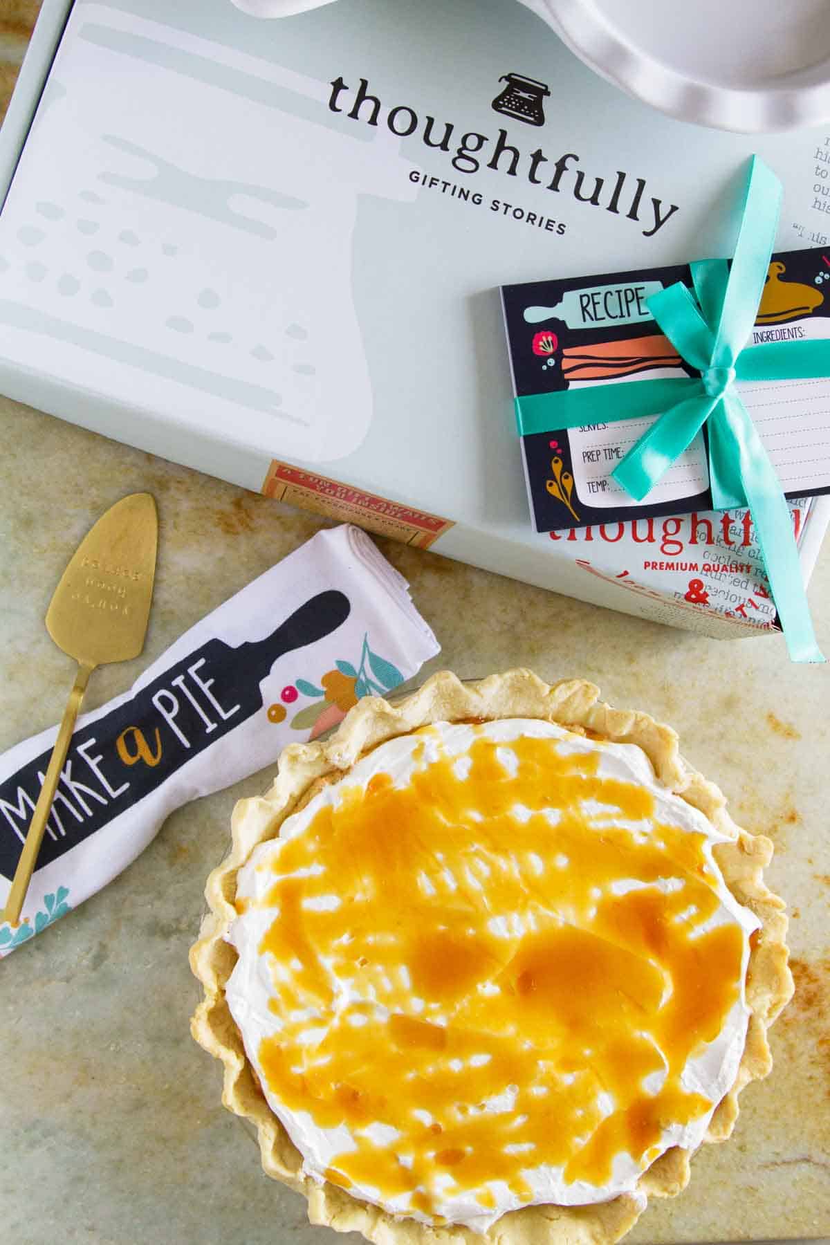 White Chocolate Caramel No Bake Pumpkin Pie surrounded by gift box from Thoughtfully.
