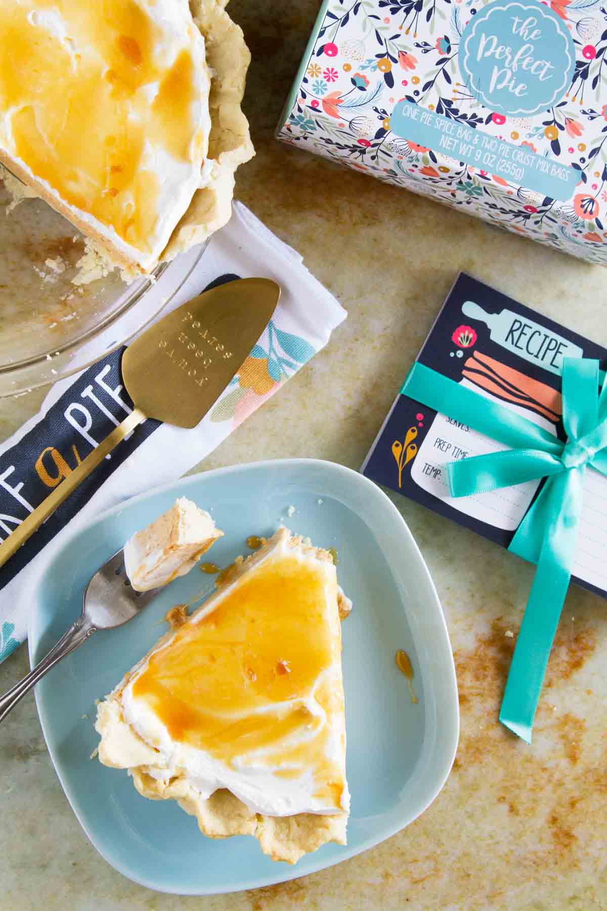 Slice of White Chocolate Caramel No Bake Pumpkin Pie on a blue plate with a bite taken from it.