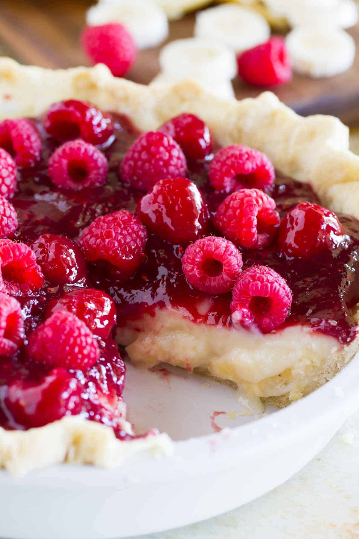 Raspberry Banana Pie with a slice taken from it.