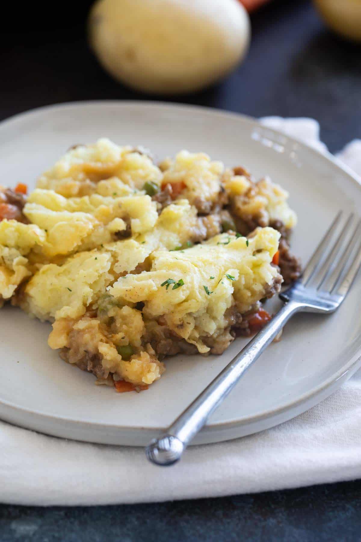 Plate with a serving of Shepherd's Pie with a fork.
