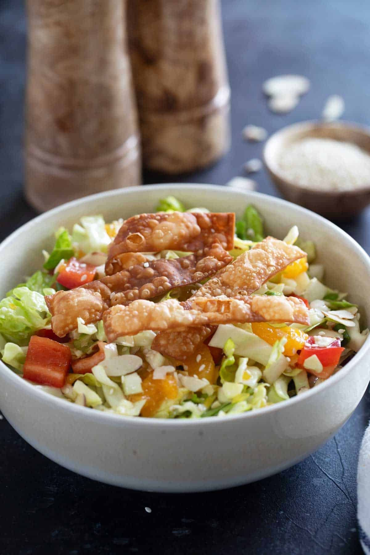 Asian Chopped Salad with cabbage, romaine, bell peppers, oranges, and wonton strips.
