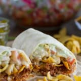 Frito Pie Burrito with chili, Fritos, pico de Gallo, and green Chile queso.
