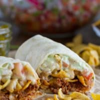 Frito Pie Burrito with chili, Fritos, pico de Gallo, and green Chile queso.