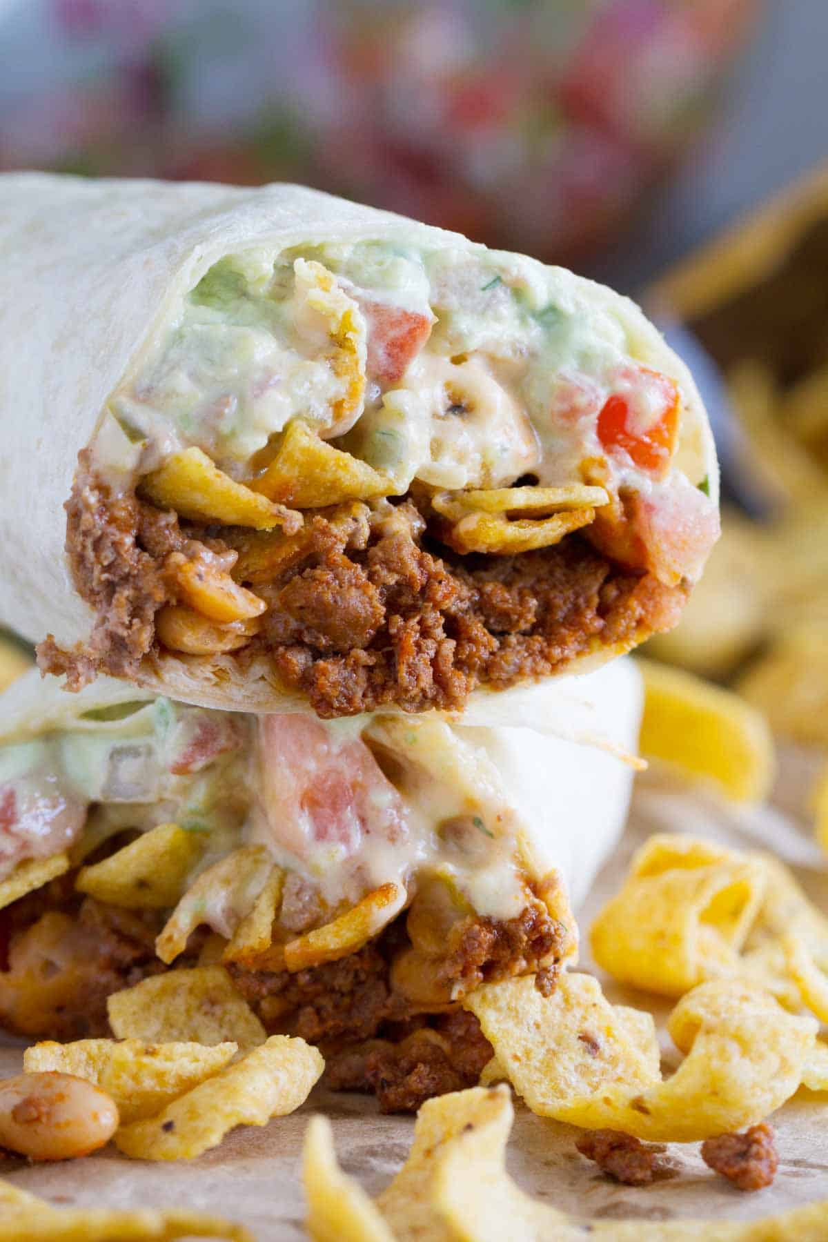 Halves of a Frito Pie Burrito stacked on top of each other.