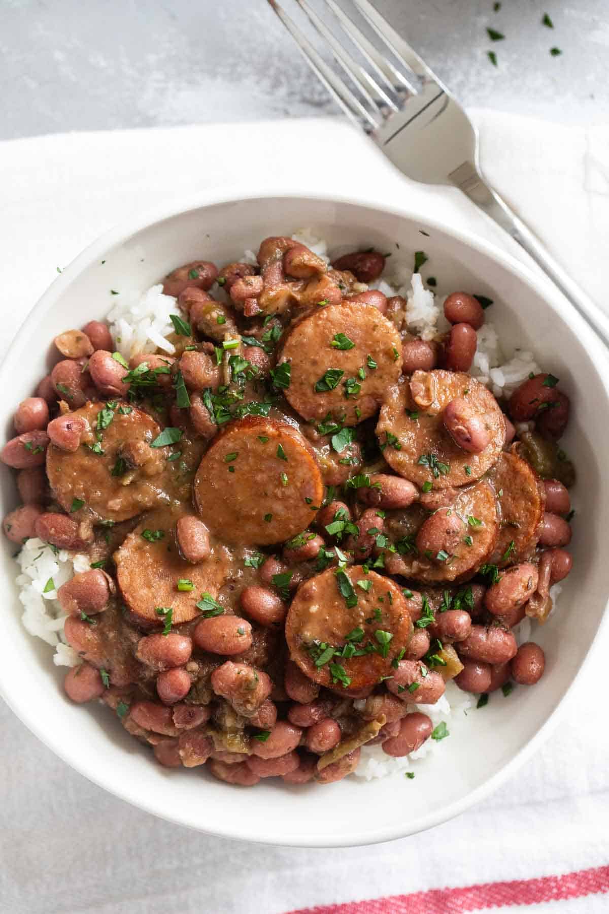 Bowl of red beans and rice with andouille sausage.