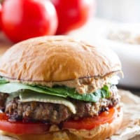 Brie Burger with Sun-Dried Tomato and Artichoke Spread with lettuce and tomatoes.