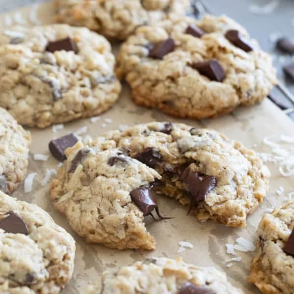 Chocolate Chunk Oatmeal Coconut Cookies on a cooling rack, with one cookie broken in half.