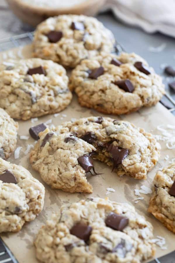 Chocolate Chunk Oatmeal Coconut Cookies on a cooling rack, with one cookie broken in half.