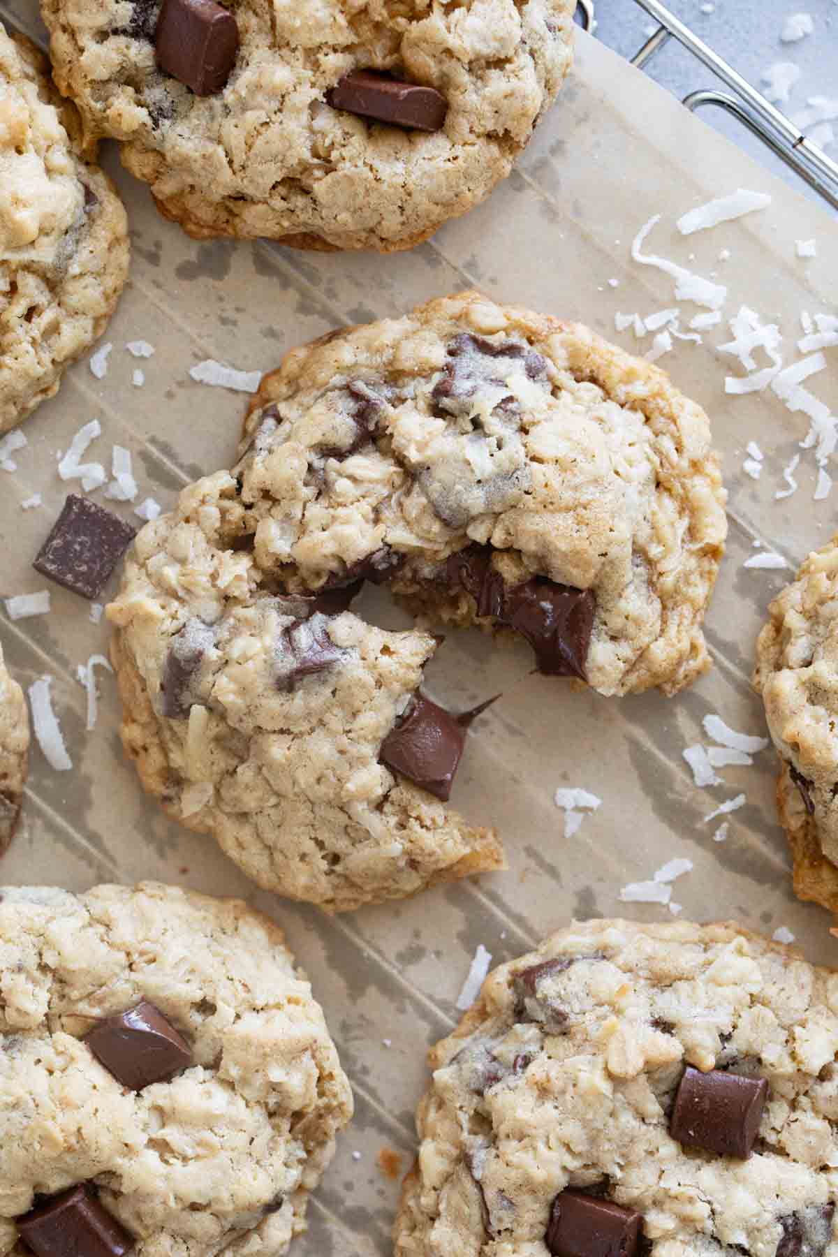 Cookie with oatmeal, coconut, and chocolate chunks broken in half.