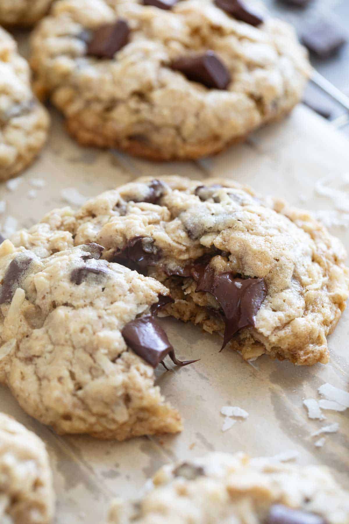 Chocolate Chunk Oatmeal Coconut Cookie torn in half to show melted chocolate.