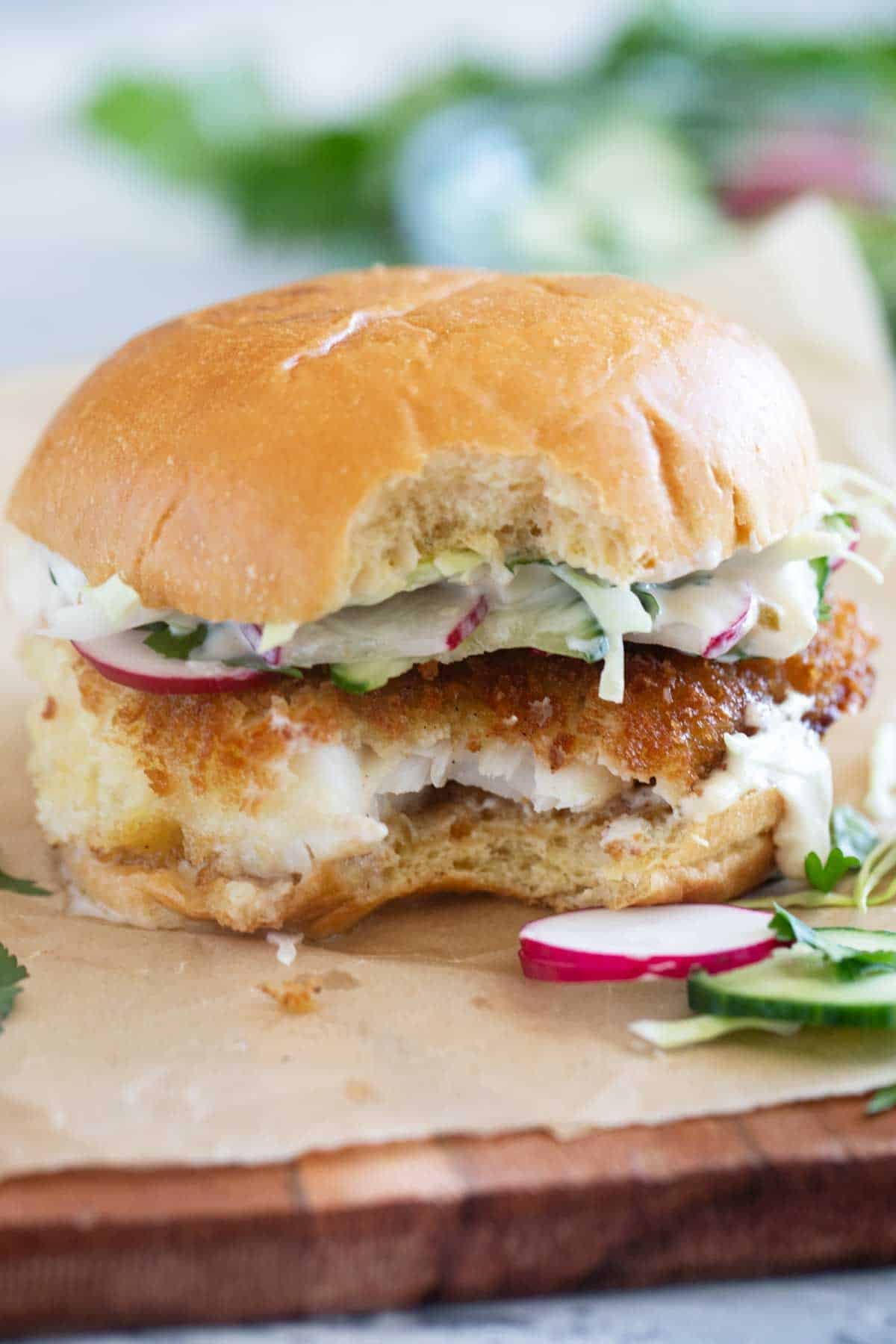 Crispy Fish Sandwich with a bite taken from it.