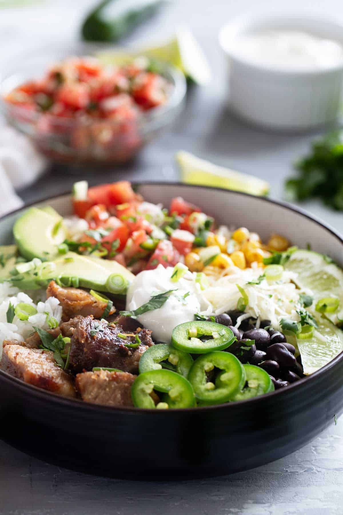 Pork Carnitas Burrito Bowl with pico de gallo, cheese, sour cream, and more!