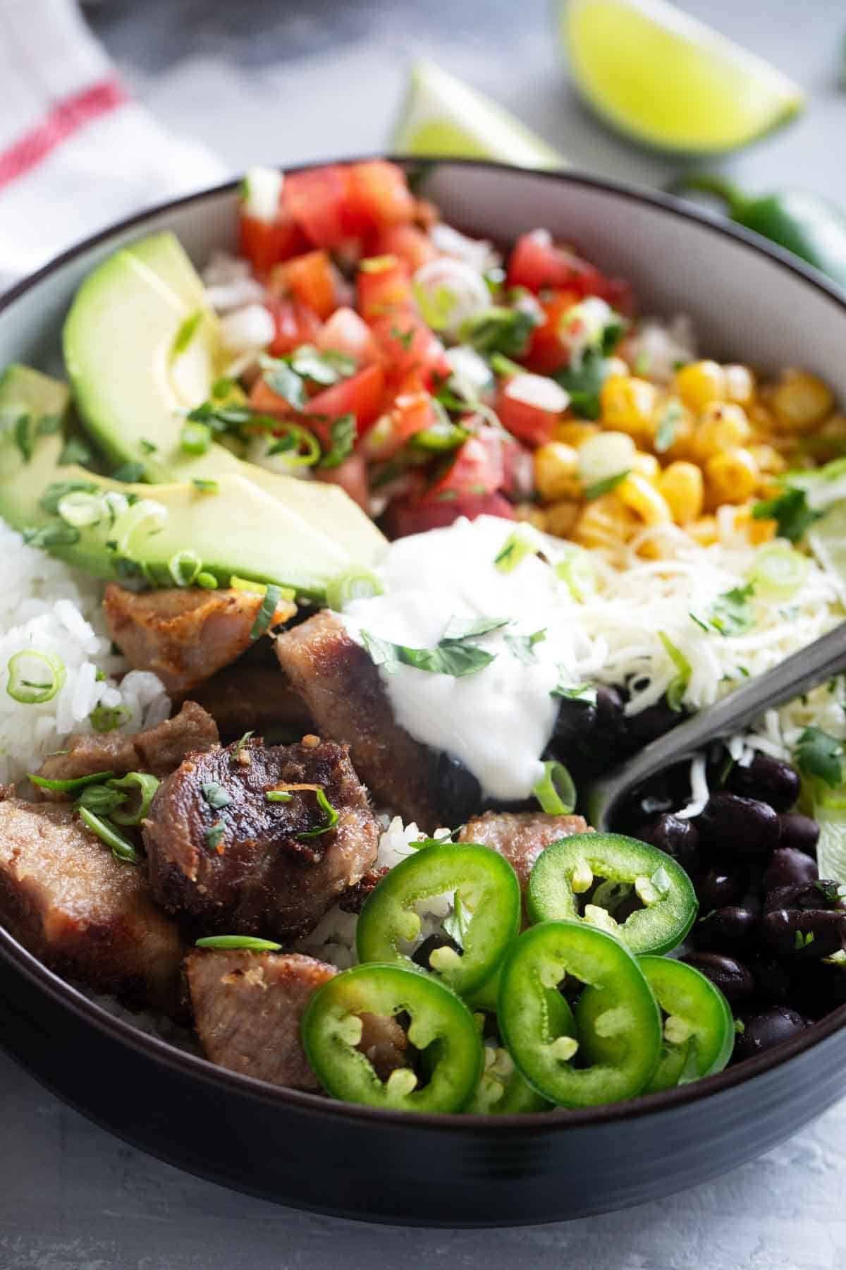 Pork Carnitas Burrito Bowl with a fork in it.
