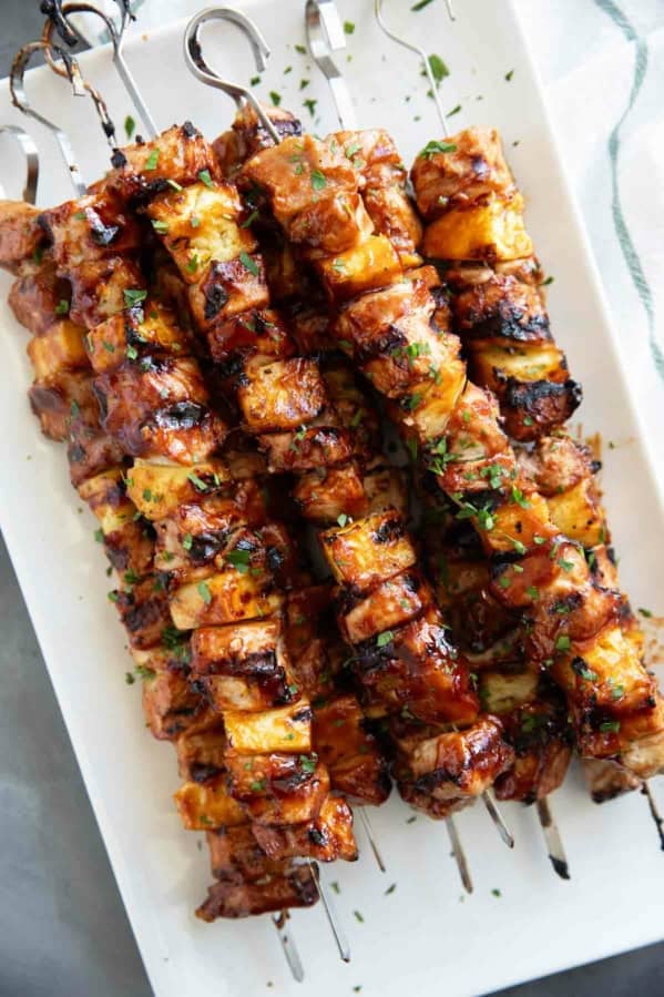 BBQ Pork Kabobs with Pineapple stacked on a plate.