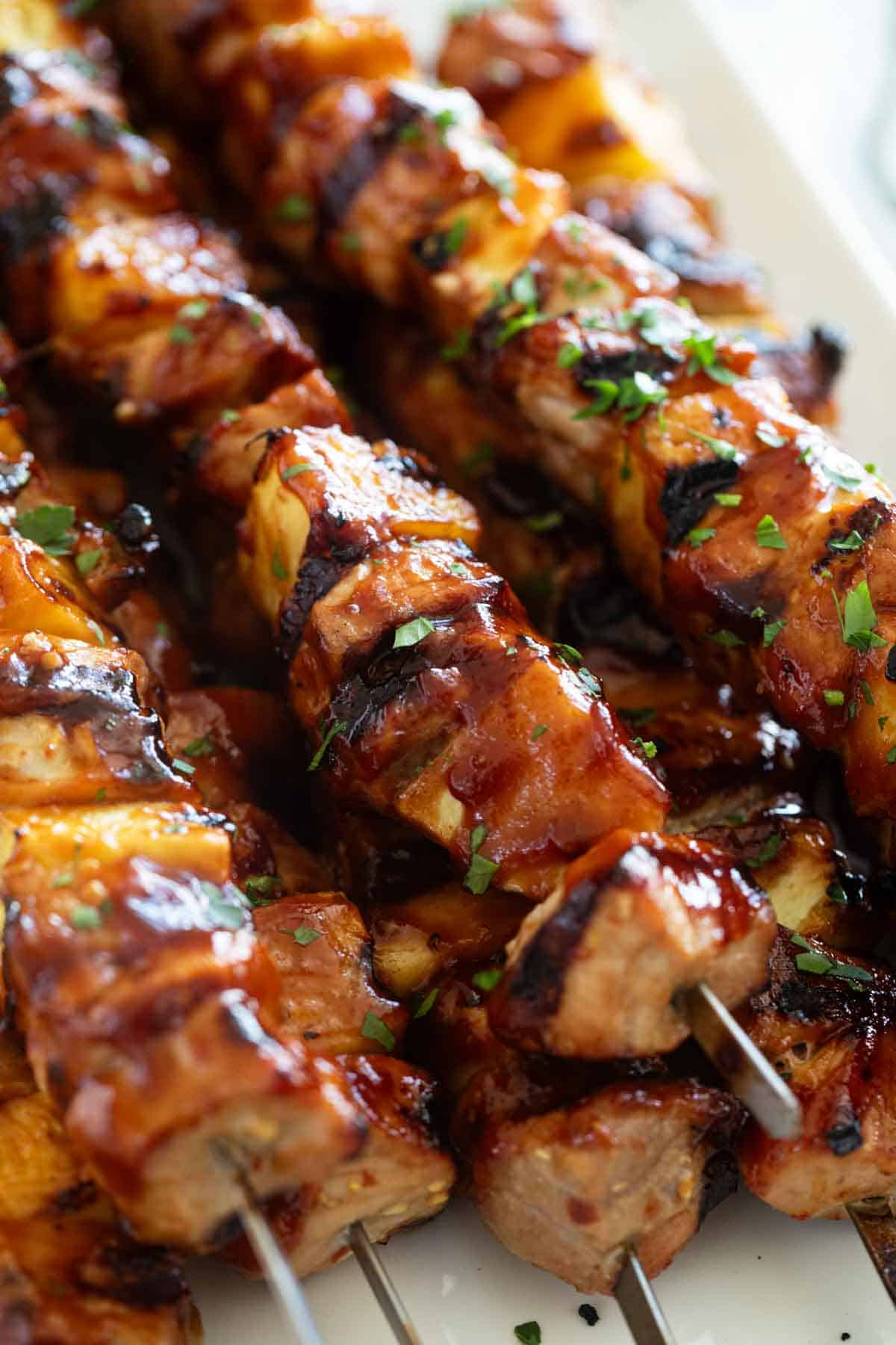Kabobs made with chunks of pork, pineapple, and bbq sauce.