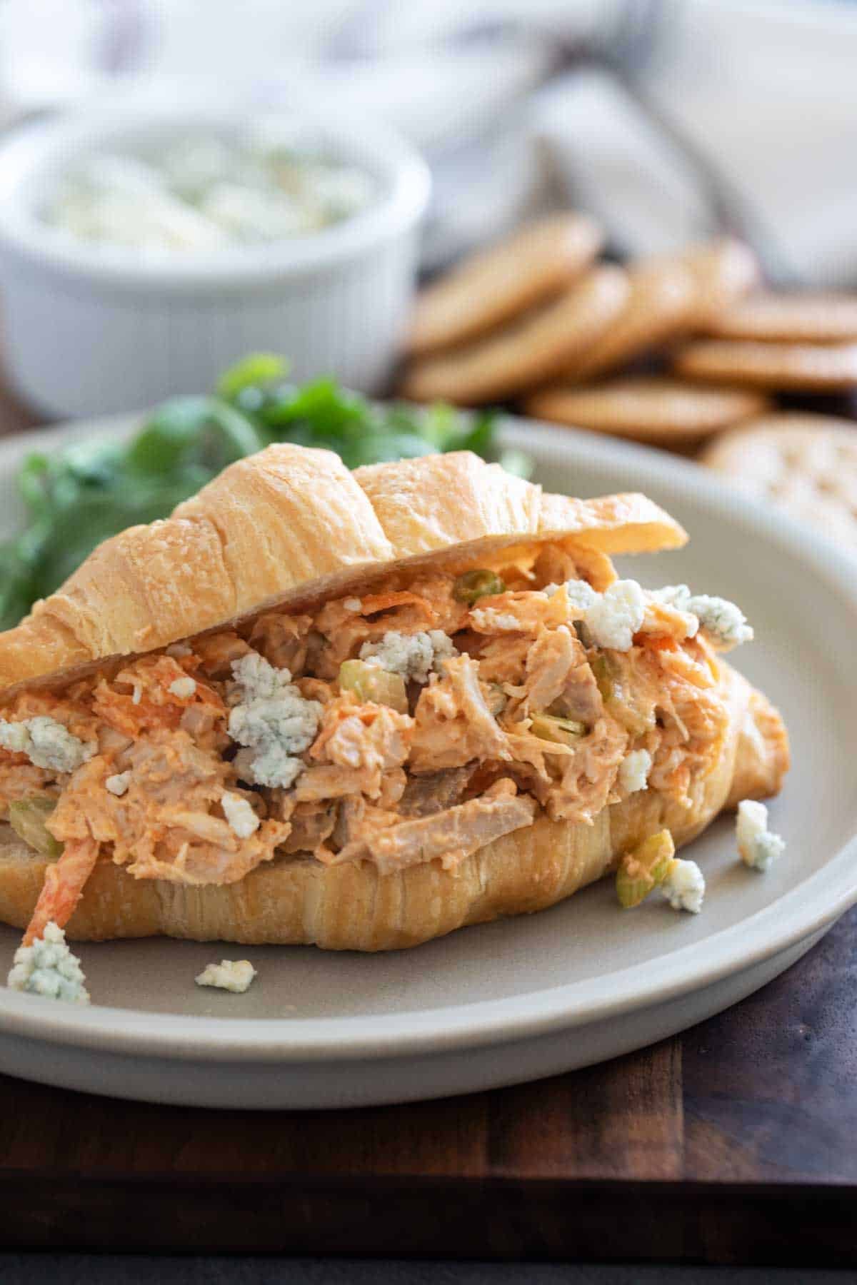 Buffalo chicken salad with blue cheese in a croissant.