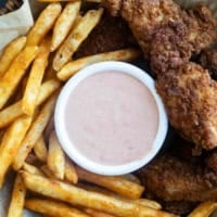 Basket filled with fries, chicken tenders, and Comeback Sauce.
