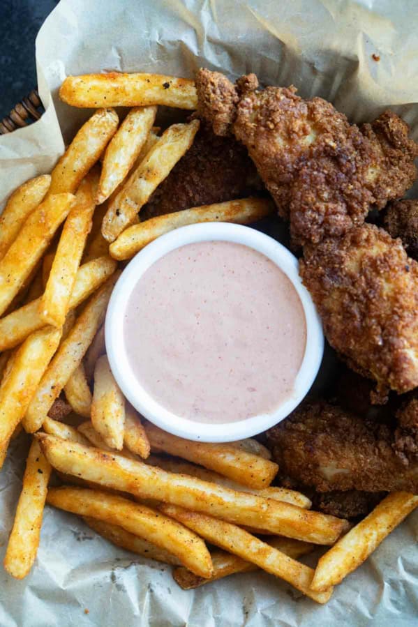 Basket filled with fries, chicken tenders, and Comeback Sauce.